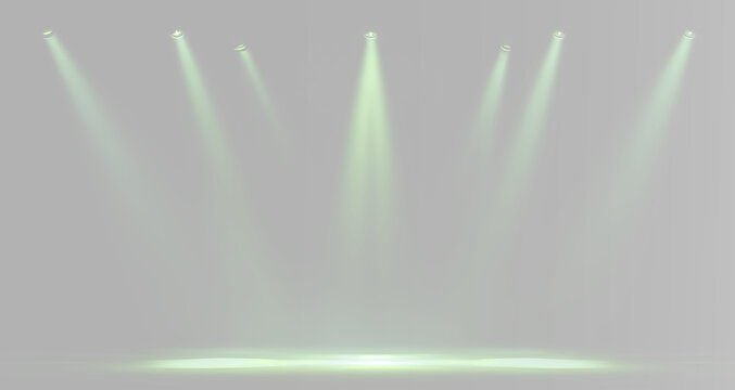 Green theatrical spotlights arranged in a row and illuminating the central stage with powerful glowing beams