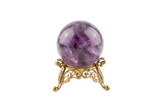 Amethyst crystal ball gemstone sphere on ornate vintage gold stand.