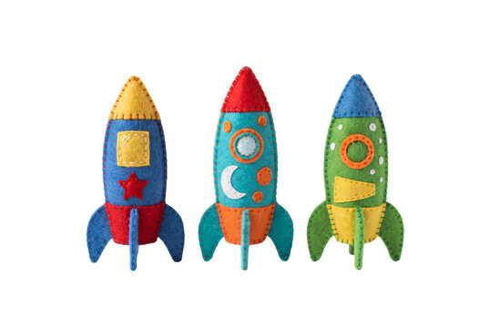 Three colorful handcrafted felt toy space rockets featuring stitched details and star shapes for children's room decoration.