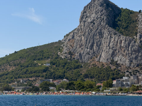 Rocky mountain rising directly above an Adriatic town