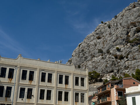 Historic Mediterranean building beneath a limestone cliff