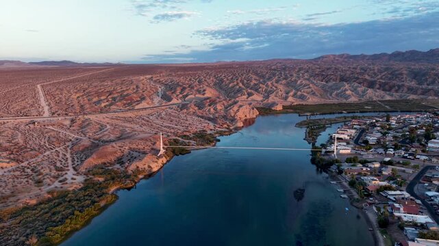 Cinematic aerial shot of the Colorado River at Sunrise, cutting through the Mojave Desert. Beautiful Cloud Reflections! js
