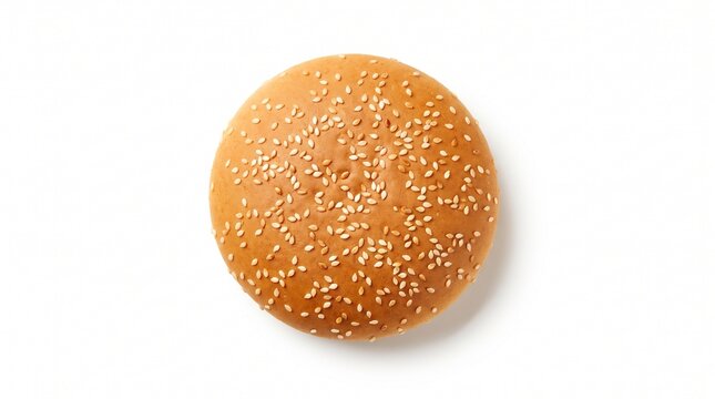 Hamburger bun covered in white sesame seeds resting on a clean white background from above.