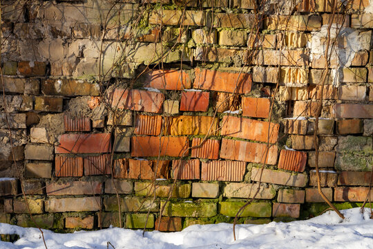 Old abandoned brick wall in winter. Architectural detail.