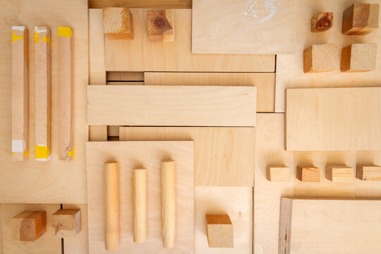 Flat lay of various wood and plywood pieces. Carpentry background.