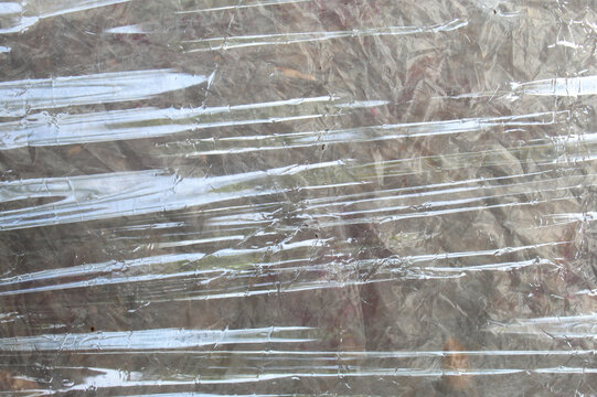 Abstract Background Texture of Pulled and Crumpled Clear Plastic Wrapping