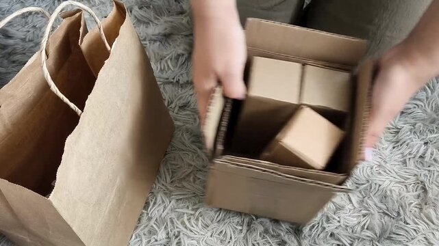 Woman organizing cardboard boxes, paper bags and recyclable paper, waste management, recycling and eco friendly lifestyle concept.