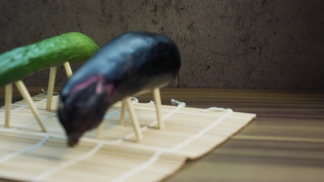 Close-Up of Eggplant and Cucumber Animals Standing on Toothpick Legs