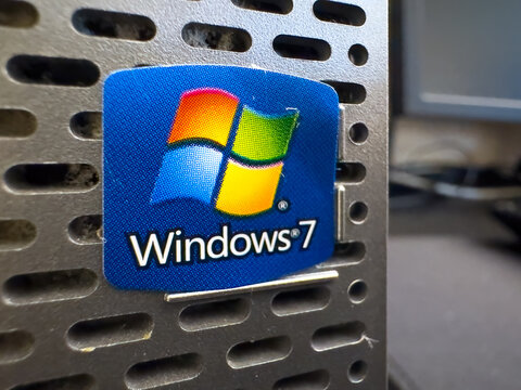 Ottawa, ON, Canada. Aug 20, 2026. Extreme macro focus on Microsoft Windows 7 sticker emblem adhered to a metal computer desktop tower case.