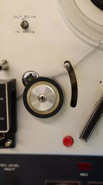 Vintage reel-to-reel audio tape recorder playing