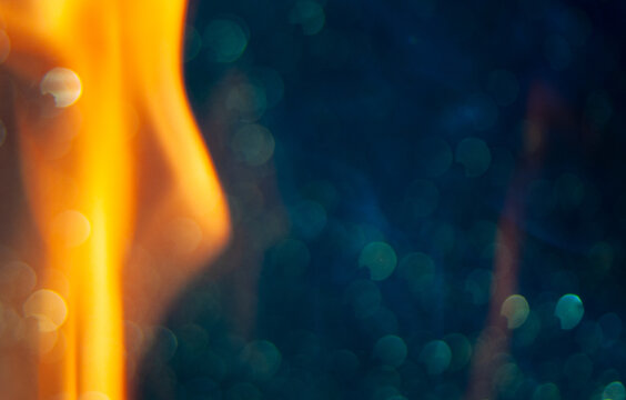 Bright flame burns with bright colors against a dark background