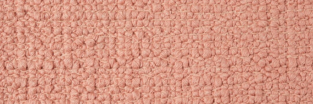 Pink boucl&eacute; fabric texture, soft rose wool textile background, elegant coral woven upholstery material, luxury dusty pink carpet surface for interior design and fashion mockups.