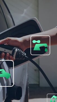 Animation of eco icons and data processing over caucasian man charging electric car
