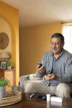Senior man checking a glucose meter during his diabetes routine at home