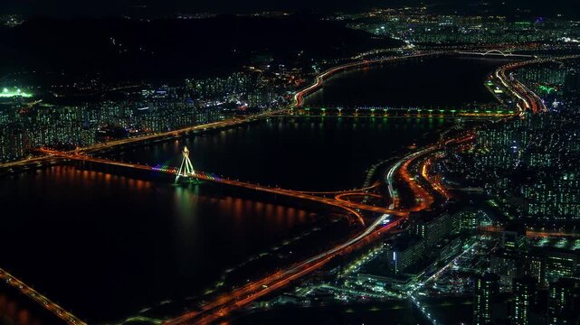 Aerial Night View of City Lights and Bridges Over a River