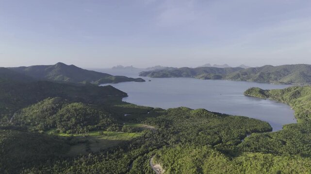 Aerial drone view of Coastal farms bordered by mangroves along a bay in Northern Palawan, Philippines