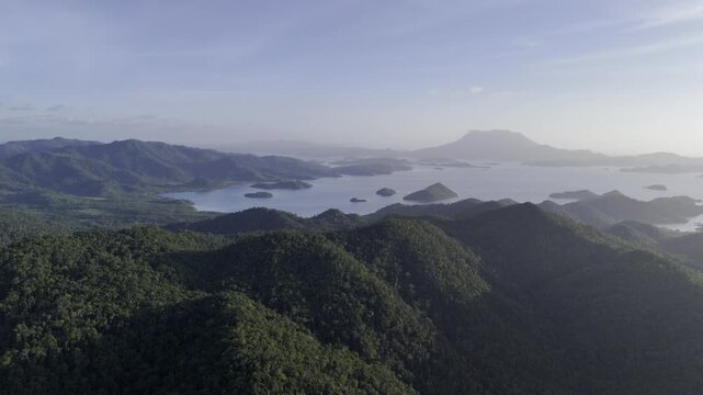 Aerial drone view of Lush coastal forests and distant islands across Northern Palawan, Philippines