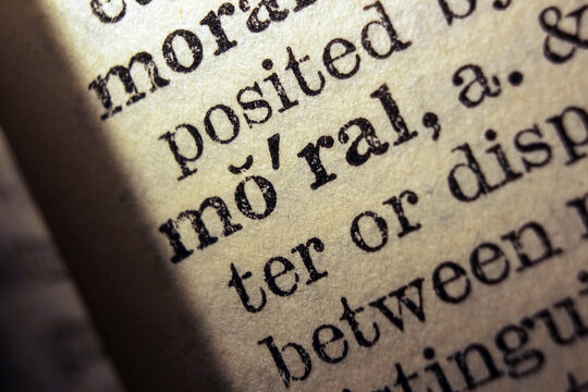 Word moral printed on dictionary page, macro close up