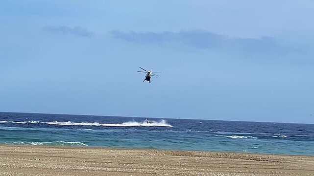 Civil Guard helicopter pursuing a drug traffickers' boat. Inflatable boat attempting to evade police interception. Spain.