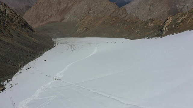 Aerial view of snowy mountain landscape with hiking trails in Xinjiang Langta