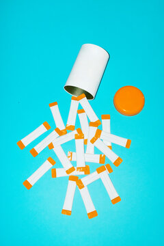 Vitamin supplement mockup spilling from container on blue background