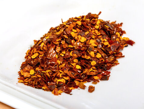 Ground hot spice pepper with seeds sprinkles pile pattern background