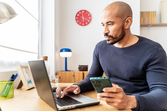 Man celebrates ecommerce and online course success at home office