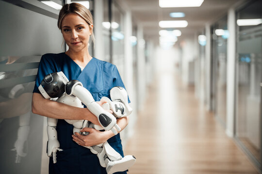 Nurse holding robot baby in hospital hallway representing AI in medicine