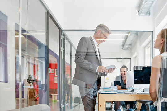 Manager talking to coworkers in office
