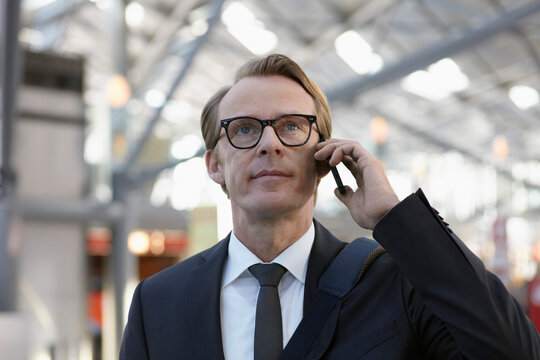 Germany, Cologne, Mature man on phone at airport