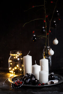 Advent decoration with white candles and black baubles