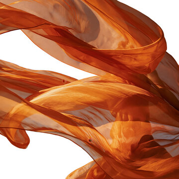 Bright orange silk fabric moves in the wind under a clear sky during a sunny day