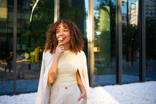 Woman enjoying ice cream outdoors on a summer day
