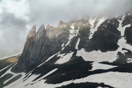 Warm-Toned Granite Spires Rising Above a Snow-Patched Ridge