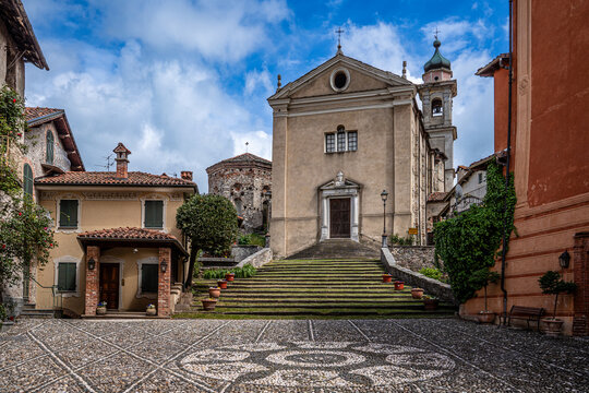 Cobblestone square and church with monumental staircase in the village of Garessio, Piedmont, Italy.