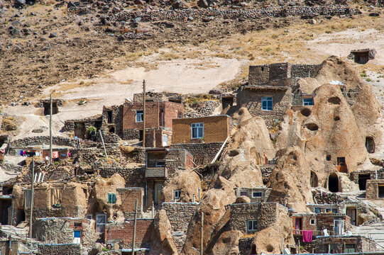 Traditional stone and brick houses terraced on the hillside of Kandovan, Iran.