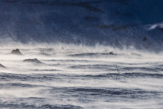 Windblown Snow Drifting Across a Frozen Arctic Landscape