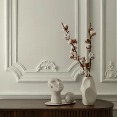 Minimalist interior decor with abstract white ceramic sculpture and cotton branch in vase against classic wall molding background for home design © FollowTheFlow