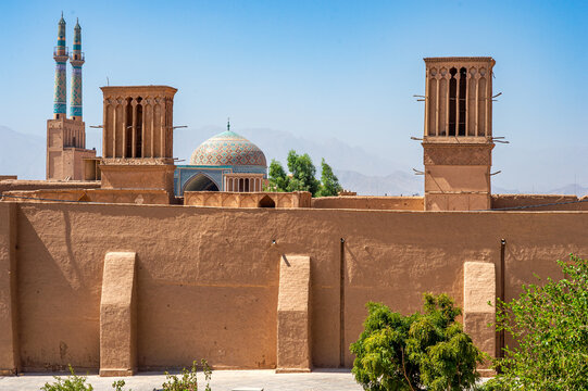 Badgir windcatcher towers and Jameh mosque dome in Yazd, Iran