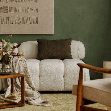Modern cozy living room interior with white boucle sofa, green accent wall, wooden furniture, and minimalist art decor for stylish home design