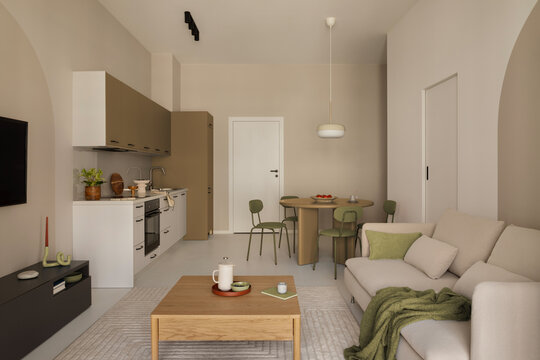 Modern open kitchen with grey cabinets, oven, and stylish details in a contemporary living space.