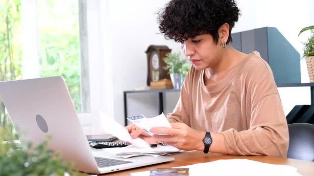 Worried stressed young asian woman holding bank statement bill feeling upset by money debt concept, financial problem. Depressed lady looking desperate about high taxes at home.