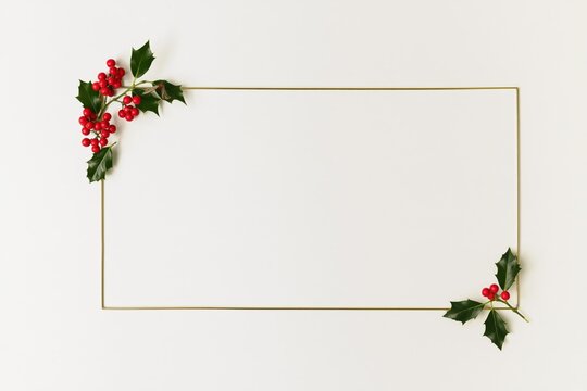 Elegant Golden Christmas Frame with Fir Branches and Red Holly Berries Holiday Border