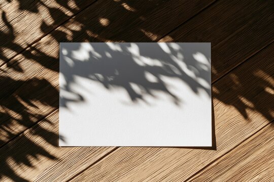 Overhead Blank White Paper Mockup on Wooden Table with Leaf Shadows