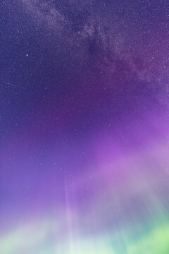 Abstract Purple and Green Aurora Under a Starry Sky
