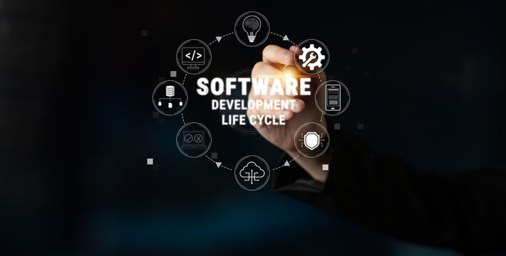Hand Using Digital Pen to Illustrate Software Development Life Cycle Concepts with Icons on Dark Background Quark.
