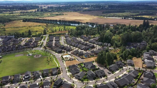 4K aerial drone footage of suburban neighborhood and residential housing in Camas, Washington, USA, showing single family homes, curved streets, real estate development and community layout