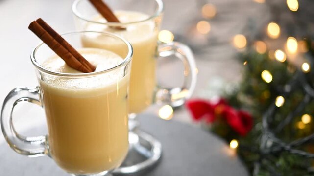 Traditional Christmas eggnog drink rotating in glass