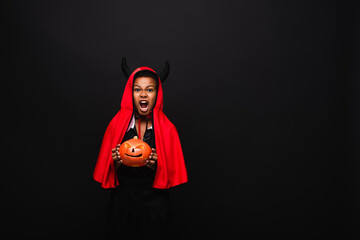 Fototapeta premium Cute african american boy joyfully celebrating halloween in a vibrant costume