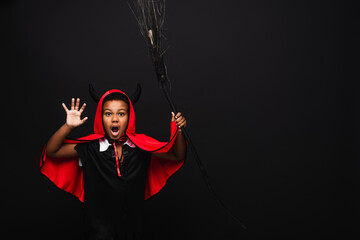 Fototapeta premium Little boy dressed in vibrant Halloween costume brings joy and spooky vibes to autumn